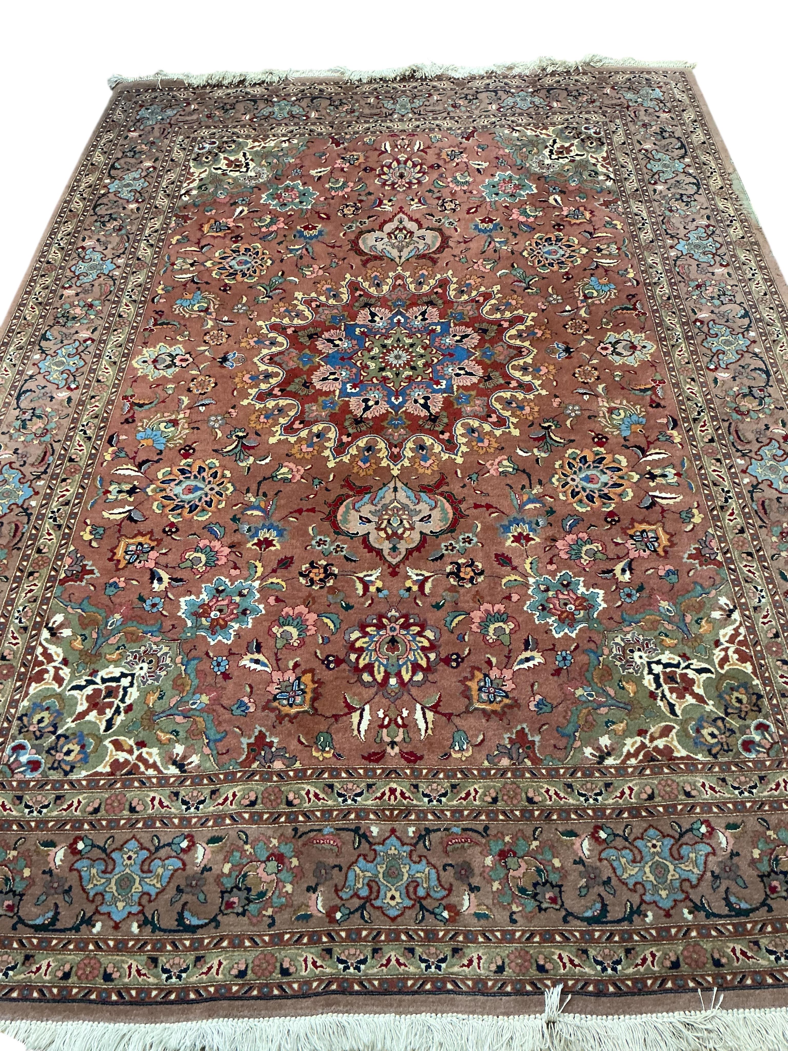 A Tabriz peach ground carpet, 292 x 205cm